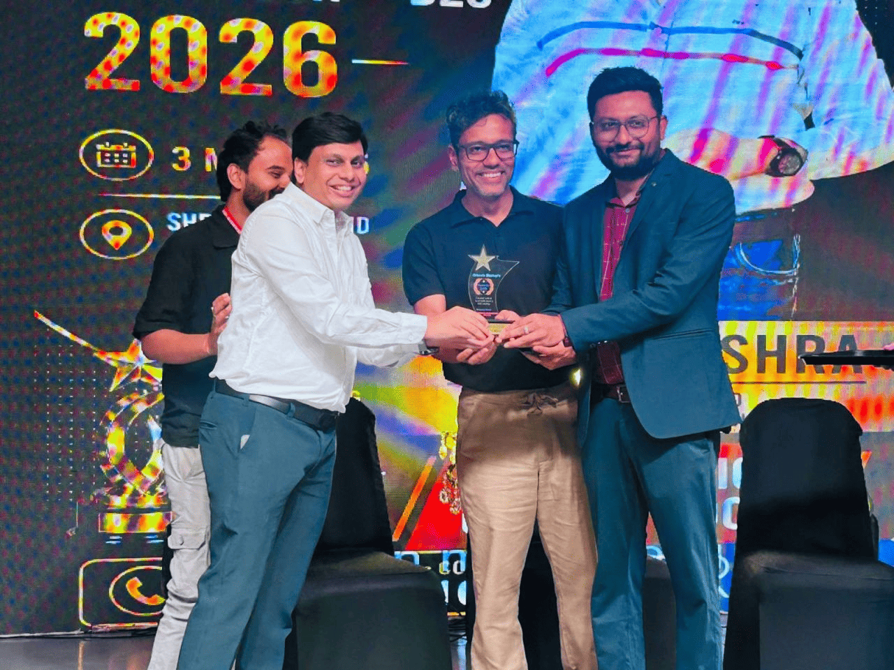 Ishan Mishra receiving an award on stage
